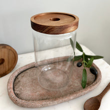 Load image into Gallery viewer, Clear glass jar with wooden lid on a stone tray with a white background