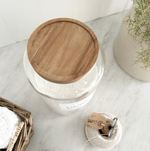 Load image into Gallery viewer, Glass jar with wooden acacia lid on a marble surface with decorative items.