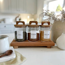 Load image into Gallery viewer, Three clear glass jars with acacia wood lids and handles, labeled 'TEA', 'COFFEE', and 'SUGAR' respectively, displayed on a wooden surface.