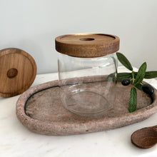 Load image into Gallery viewer, Clear glass jar with wooden lid on a stone tray with olive branch