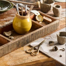 Load image into Gallery viewer, Brass scissors with hand-wrapped rattan handles resting on a rustic wooden surface — elegant artisan tool for desk, craft, or utility room decor.
